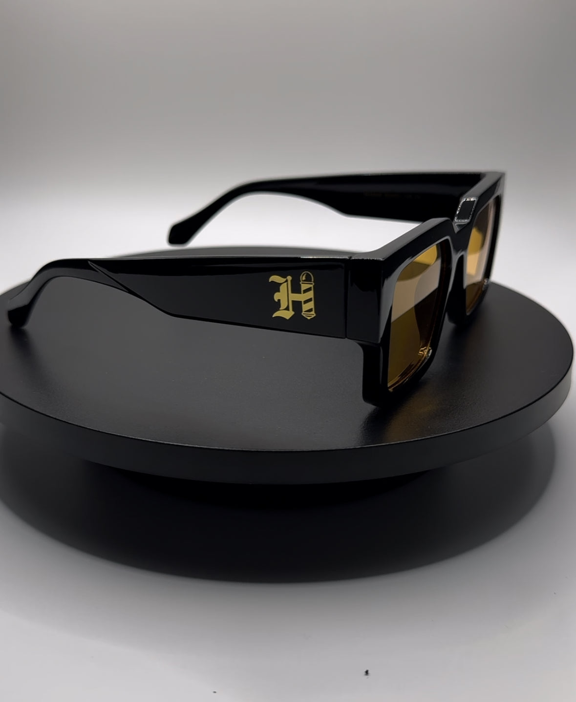 HERMS BLACK FRAME YELLOW TINT SHADE SUNGLASSES